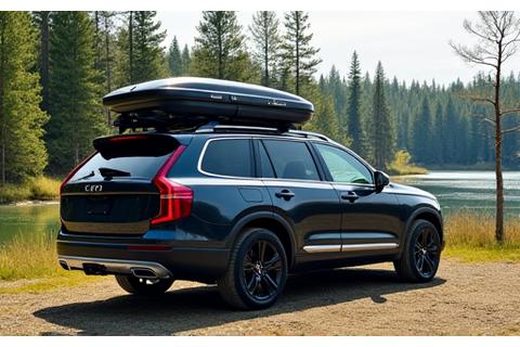 Car with a robust roof rack loaded with luggage and a large cargo box, ready for extended travel or camping.